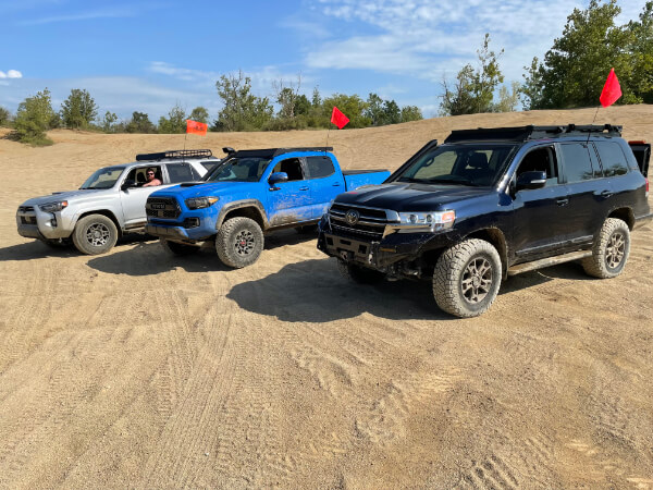 Toyota vehicles lined up on the sand for a Indiana Land Cruisers (INLC) off road event