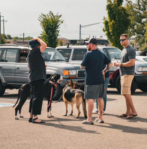 INLC Toyota 4x4 enthusiasts talking in a parking lot